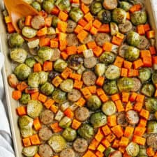 Harvest Sheet Pan Sausage and Veggies loaded with flavorful chicken sausage, butternut squash, brussels sprouts, and apples for a quick and easy dinner made in just 30 minutes! Roasted in a maple mustard glaze and fresh herbs for the perfect fall meal!