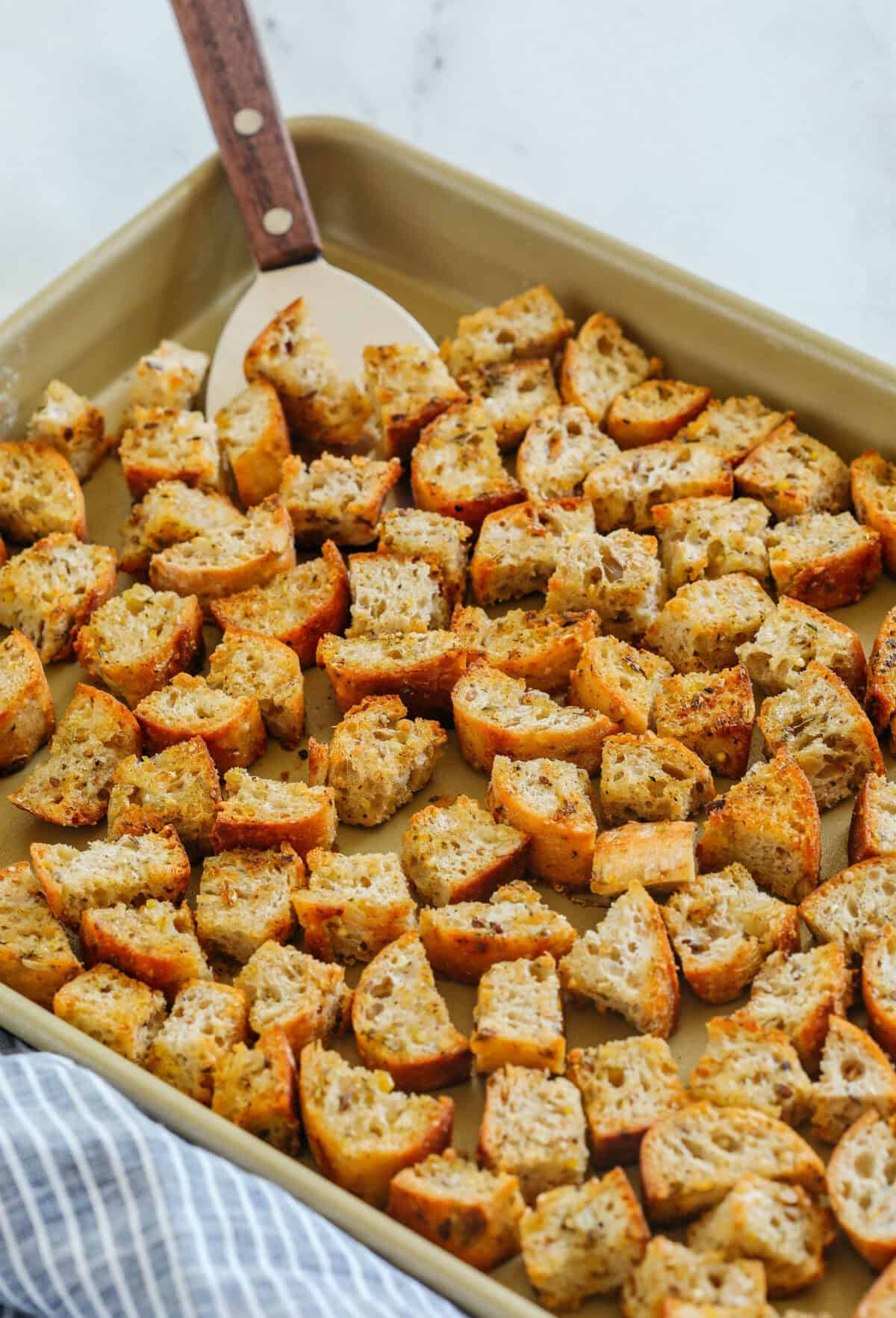 Learn how to make Easy Homemade Croutons that are crispy, garlicky and super quick to make! Use them as a topping for salads, soups, stuffing and more!