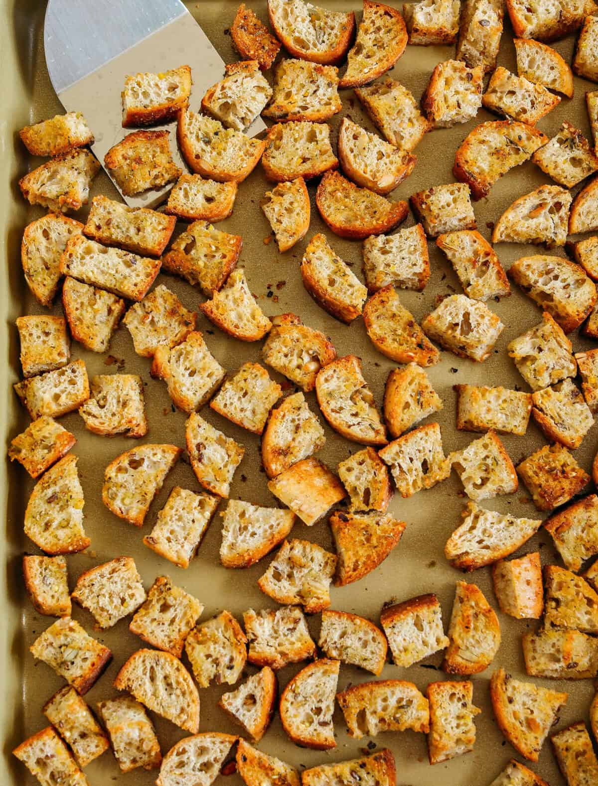 Learn how to make Easy Homemade Croutons that are crispy, garlicky and super quick to make! Use them as a topping for salads, soups, stuffing and more!