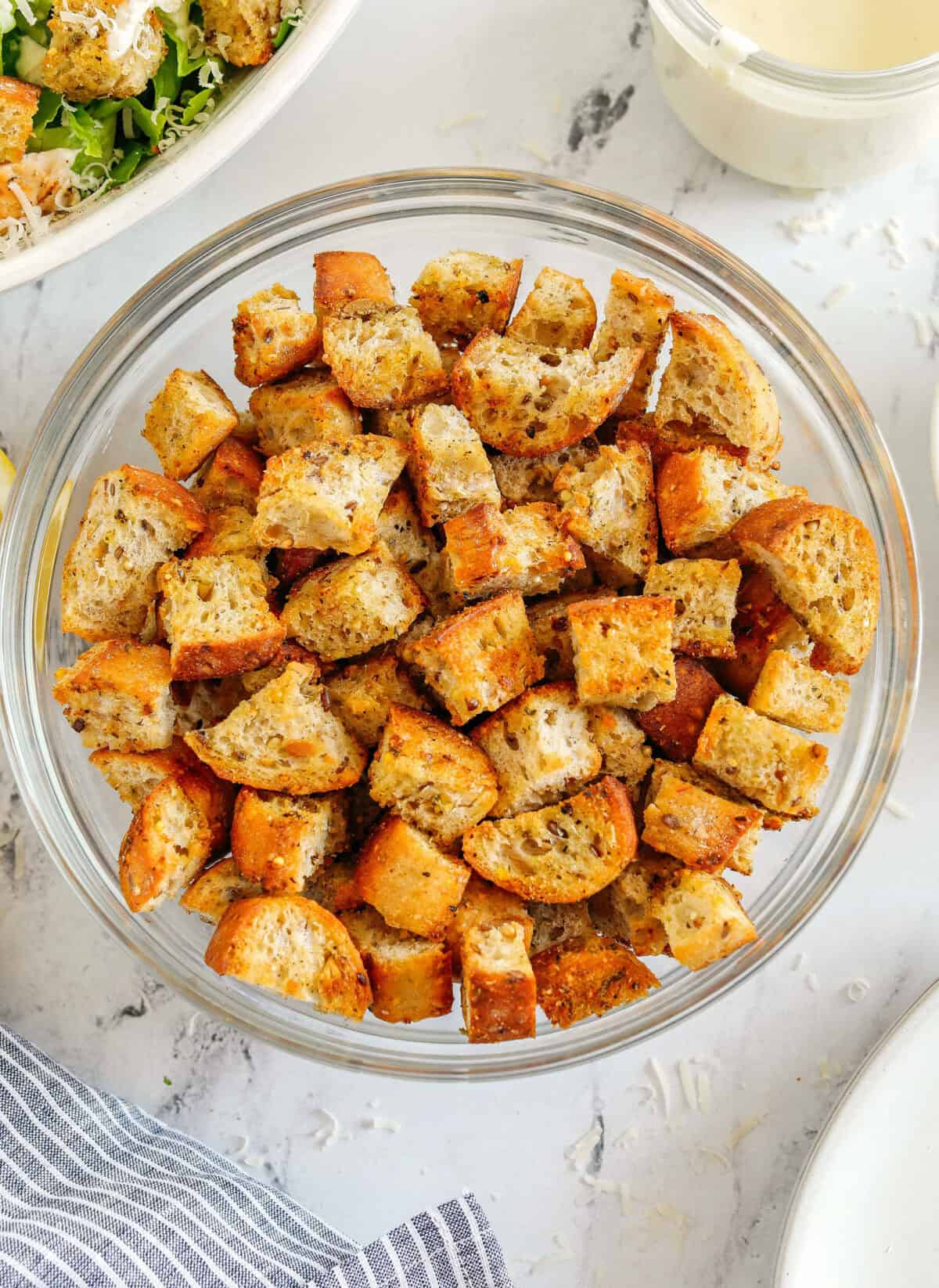 Learn how to make Easy Homemade Croutons that are crispy, garlicky and super quick to make! Use them as a topping for salads, soups, stuffing and more!