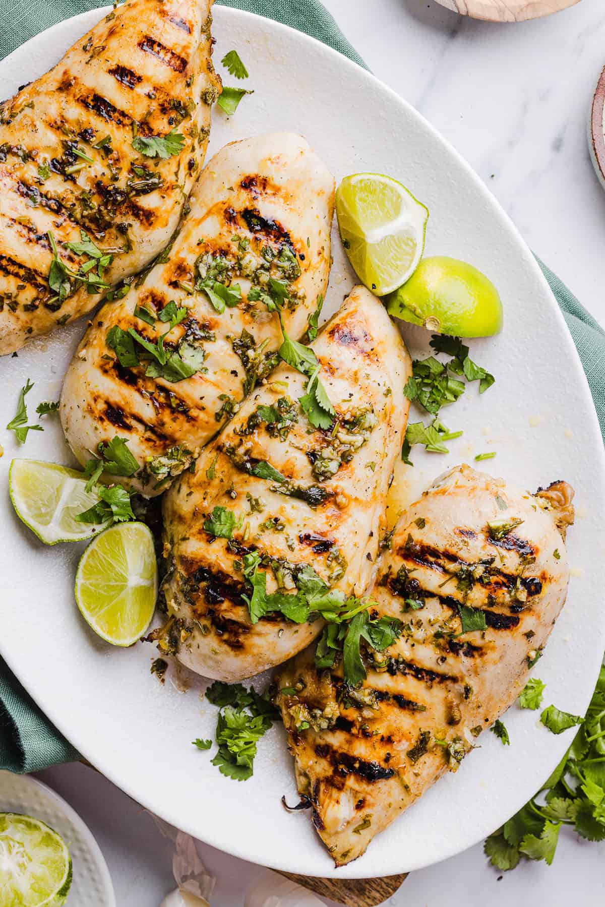 This Cilantro Lime Grilled Chicken Recipe is packed with so much zesty flavor and easily made with just a few simple ingredients! A delicious, healthy meal you can serve in tacos, on salads or over rice.