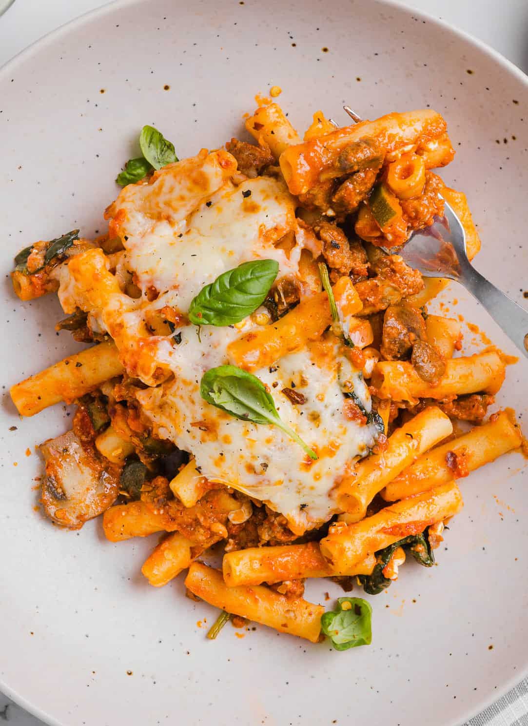 Comforting and delicious Healthy Baked Ziti packed with veggies, flavorful turkey sausage and makes the perfect weeknight meal the whole family will love! Leftovers guaranteed!