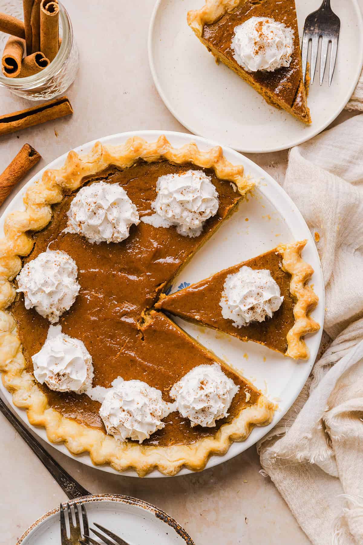 This creamy and delicious Healthy Pumpkin Pie makes the perfect holiday dessert! So easy to make, naturally sweetened with maple syrup and tastes great topped with whipped cream or vanilla ice cream!
