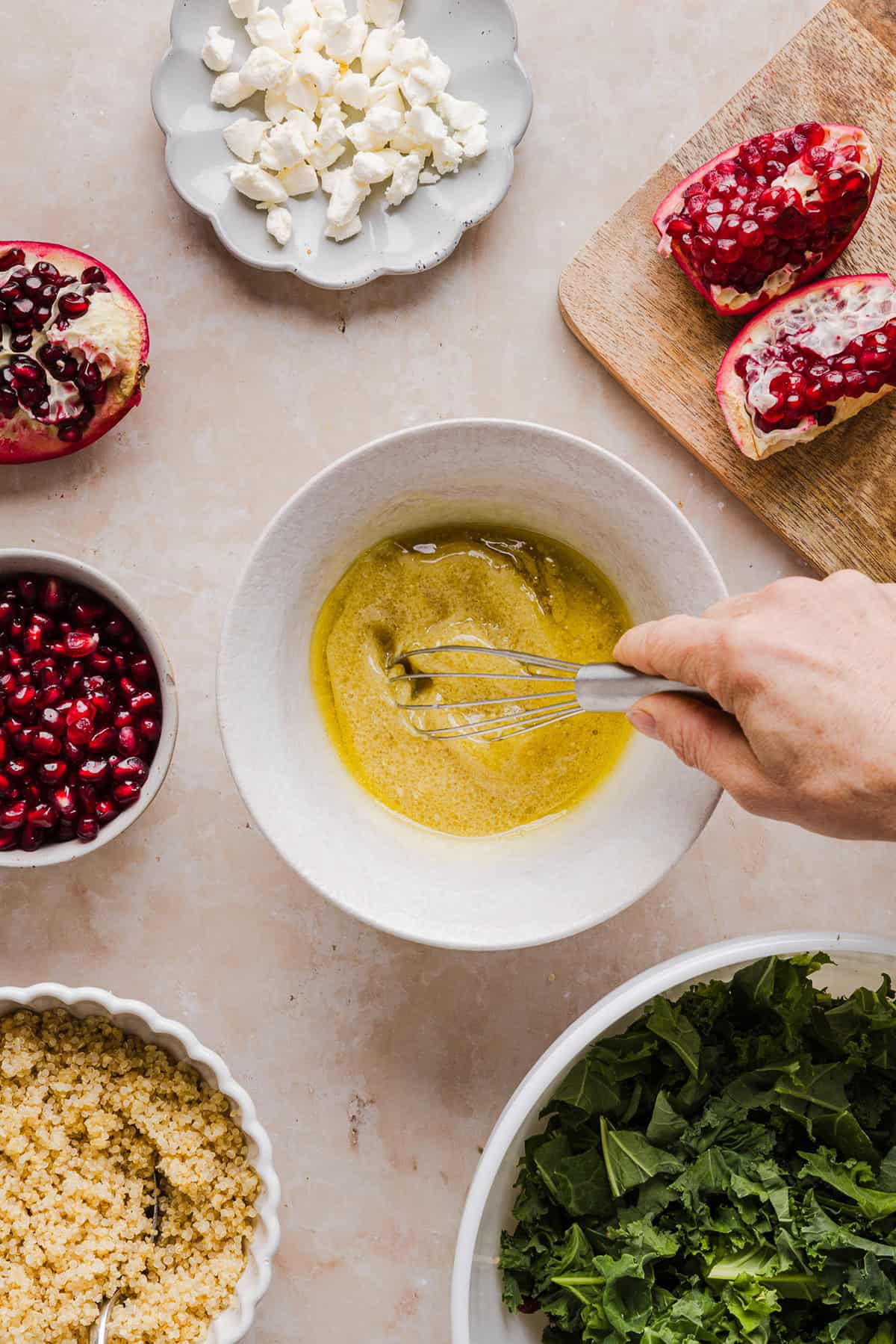 This Winter Kale and Quinoa Salad is a vibrant, wholesome salad that is bursting with flavor! Made with leafy kale, tender quinoa, juicy pomegranate seeds and crunchy walnuts all tossed together with a light dijon vinaigrette for the perfect holiday side dish!