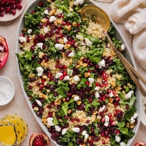 This Winter Kale and Quinoa Salad is a vibrant, wholesome salad that is bursting with flavor! Made with leafy kale, tender quinoa, juicy pomegranate seeds and crunchy walnuts all tossed together with a light dijon vinaigrette for the perfect holiday side dish!