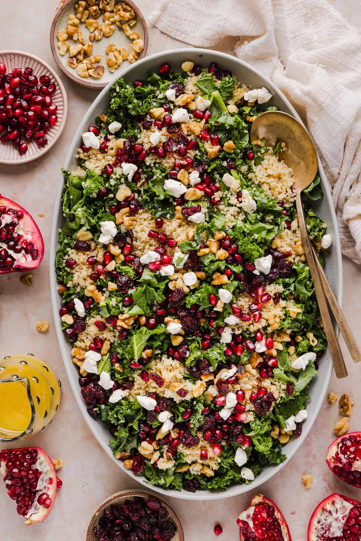 This Winter Kale and Quinoa Salad is a vibrant, wholesome salad that is bursting with flavor! Made with leafy kale, tender quinoa, juicy pomegranate seeds and crunchy walnuts all tossed together with a light dijon vinaigrette for the perfect holiday side dish!