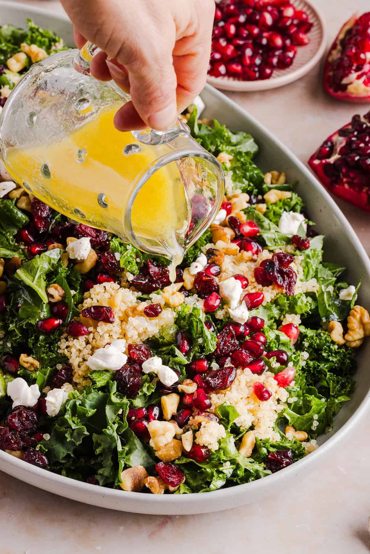 This Winter Kale and Quinoa Salad is a vibrant, wholesome salad that is bursting with flavor! Made with leafy kale, tender quinoa, juicy pomegranate seeds and crunchy walnuts all tossed together with a light dijon vinaigrette for the perfect holiday side dish!