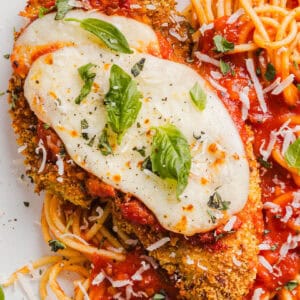 Easy Baked Chicken Parmesan made with tender juicy chicken, rich marinara sauce and melty cheese with a crisp coating that tastes delicious! This chicken is baked, not fried, and easily comes together in under 30 minutes!