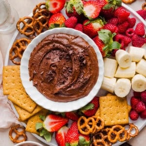 This Healthy Chocolate Hummus is rich and indulgent to satisfy your sweet tooth, but made with wholesome ingredients that you can feel good about eating! Serve with your favorite fruit, pretzels or graham crackers for the perfect fun dessert or snack!