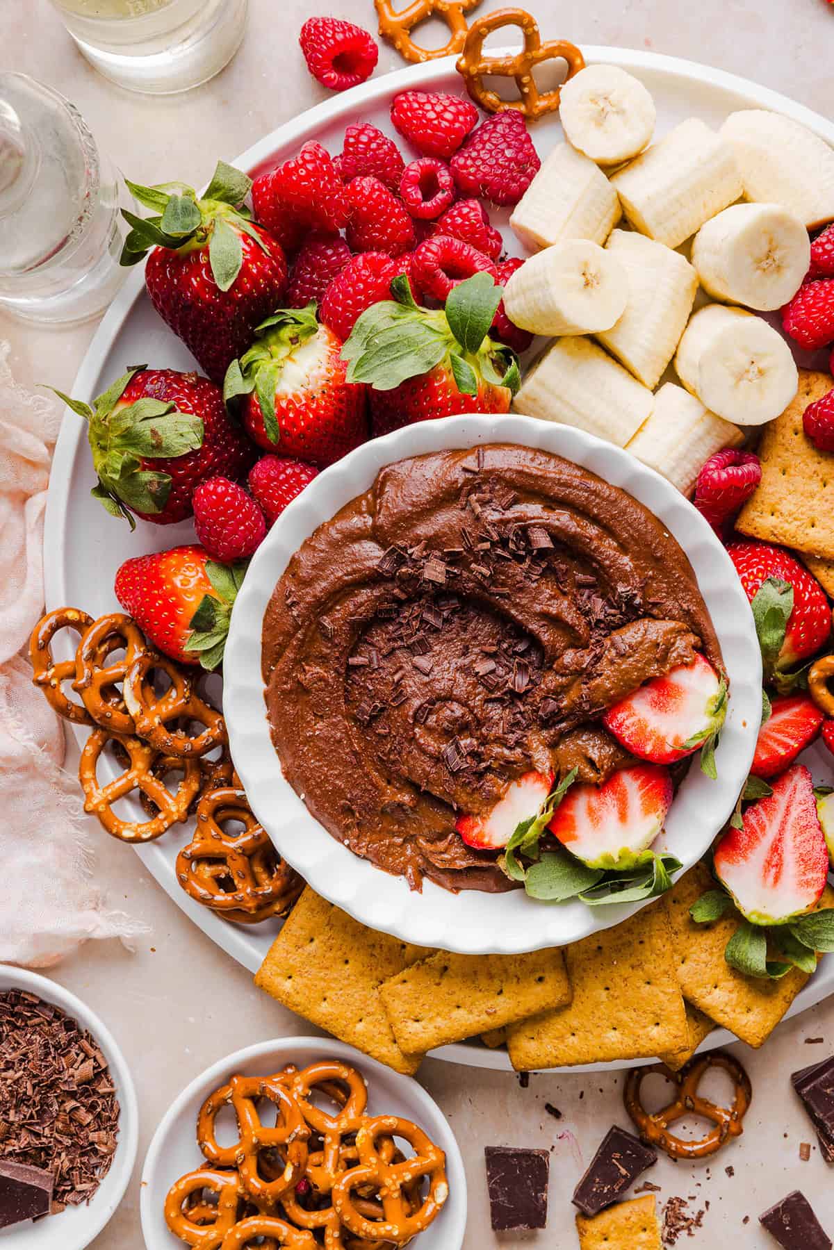 This Healthy Chocolate Hummus is rich and indulgent to satisfy your sweet tooth, but made with wholesome ingredients that you can feel good about eating! Serve with your favorite fruit, pretzels or graham crackers for the perfect fun dessert or snack!