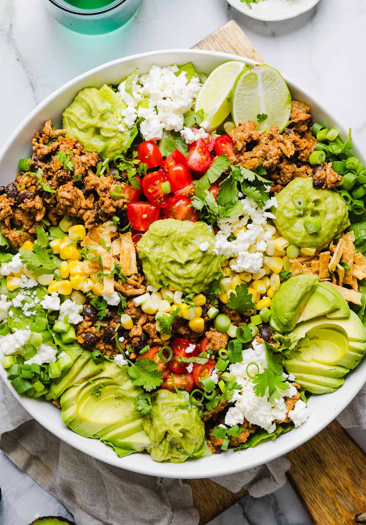 This quick and easy Healthy Taco Salad is packed with seasoned ground turkey, fresh veggies and all your favorite toppings to pack in the flavor! Perfect for busy weeknights, meal prep or even serving a crowd!