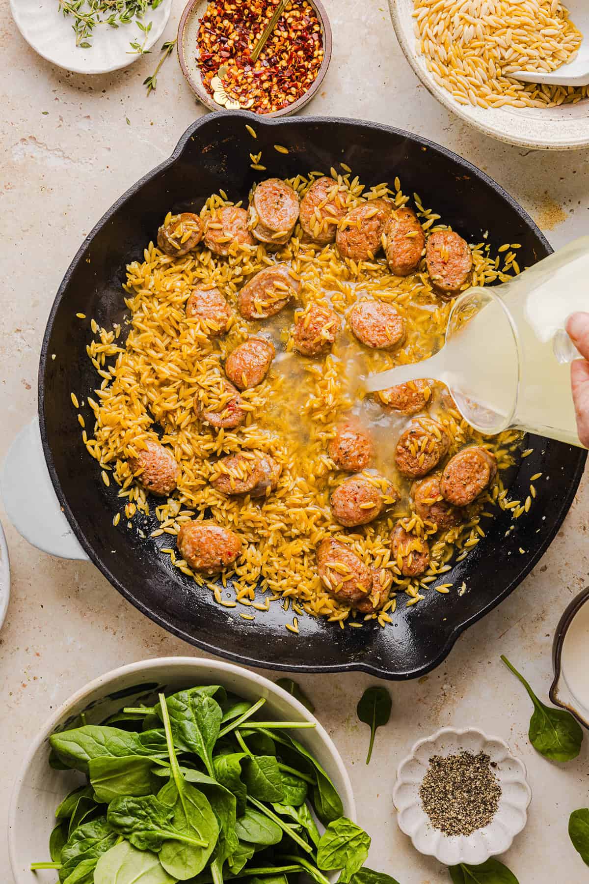 This Creamy Chicken Sausage Orzo Skillet is the perfect weeknight meal loaded with flavorful chicken sausage, tender orzo, tons of garlic and leafy spinach easily made in just 20 minutes all in one pan!  