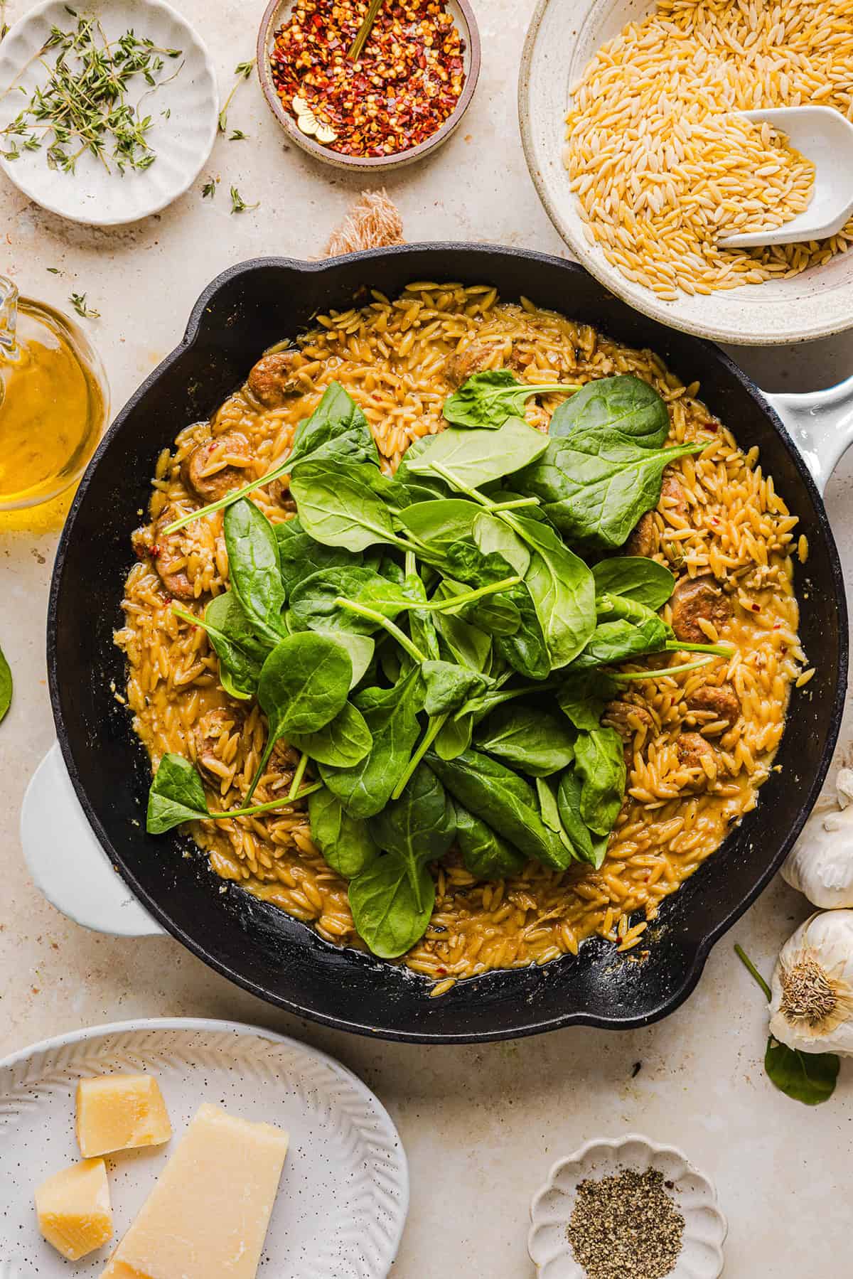 This Creamy Chicken Sausage Orzo Skillet is the perfect weeknight meal loaded with flavorful chicken sausage, tender orzo, tons of garlic and leafy spinach easily made in just 20 minutes all in one pan!  