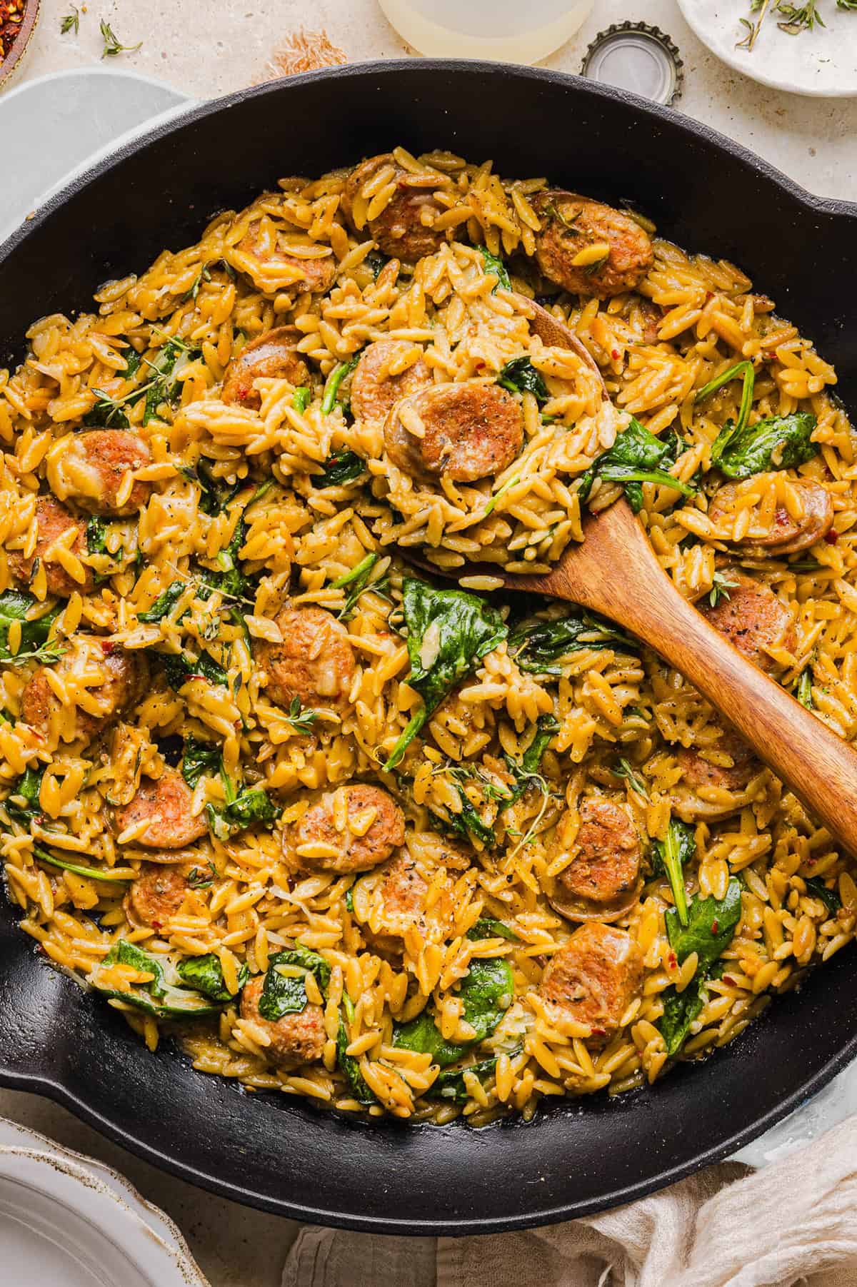 This Creamy Chicken Sausage Orzo Skillet is the perfect weeknight meal loaded with flavorful chicken sausage, tender orzo, tons of garlic and leafy spinach easily made in just 20 minutes all in one pan!  