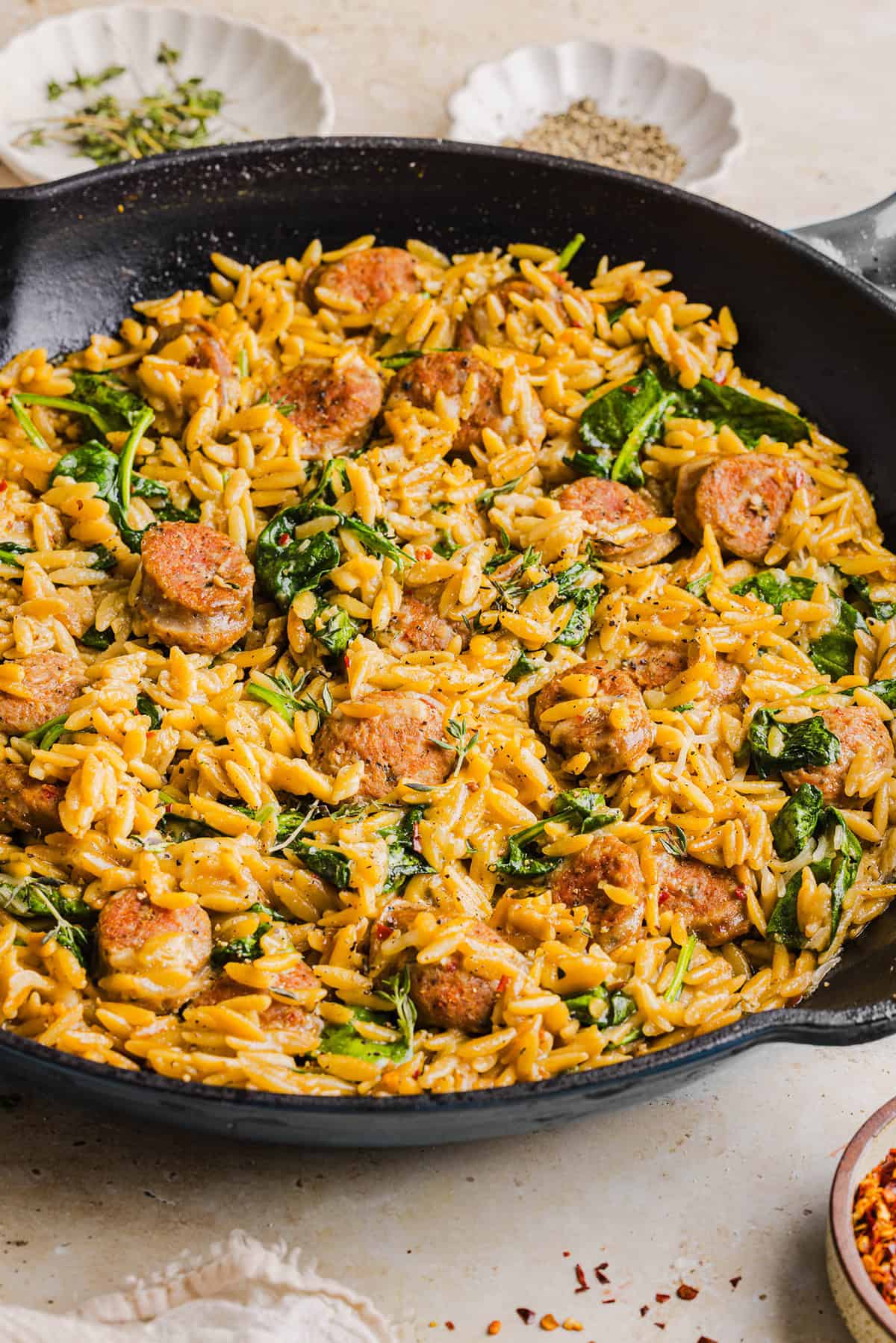 This Creamy Chicken Sausage Orzo Skillet is the perfect weeknight meal loaded with flavorful chicken sausage, tender orzo, tons of garlic and leafy spinach easily made in just 20 minutes all in one pan!  