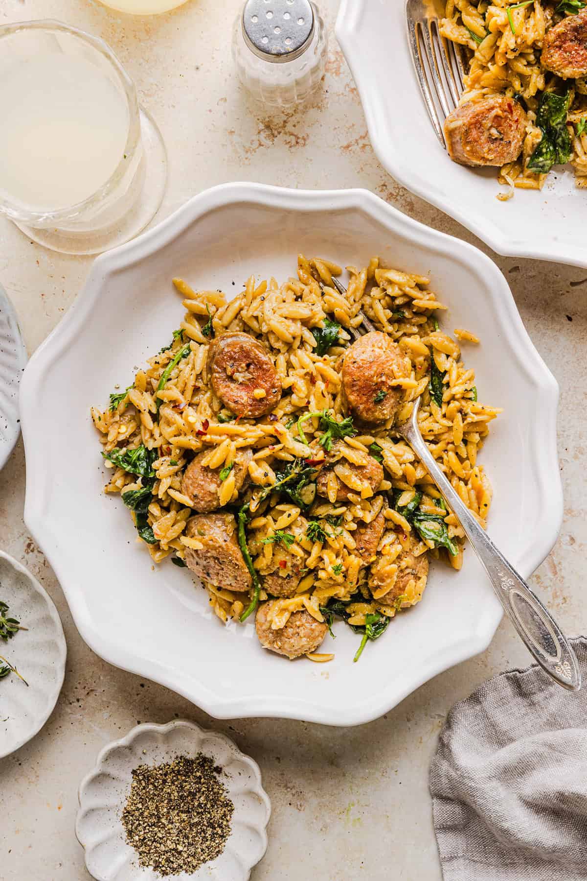 This Creamy Chicken Sausage Orzo Skillet is the perfect weeknight meal loaded with flavorful chicken sausage, tender orzo, tons of garlic and leafy spinach easily made in just 20 minutes all in one pan!  