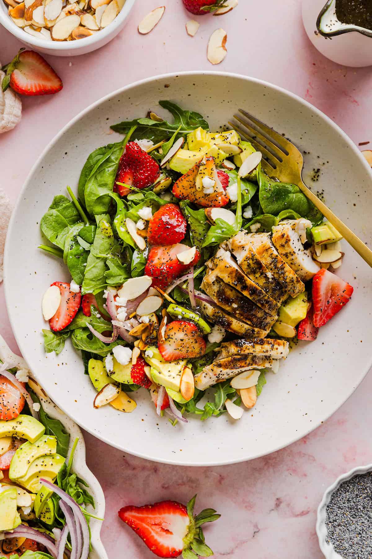 This Strawberry Poppy Seed Chicken Salad is fresh, flavorful, and perfect for spring and summer! Made with juicy strawberries, tender chicken, crunchy toppings, and the BEST poppy seed dressing.