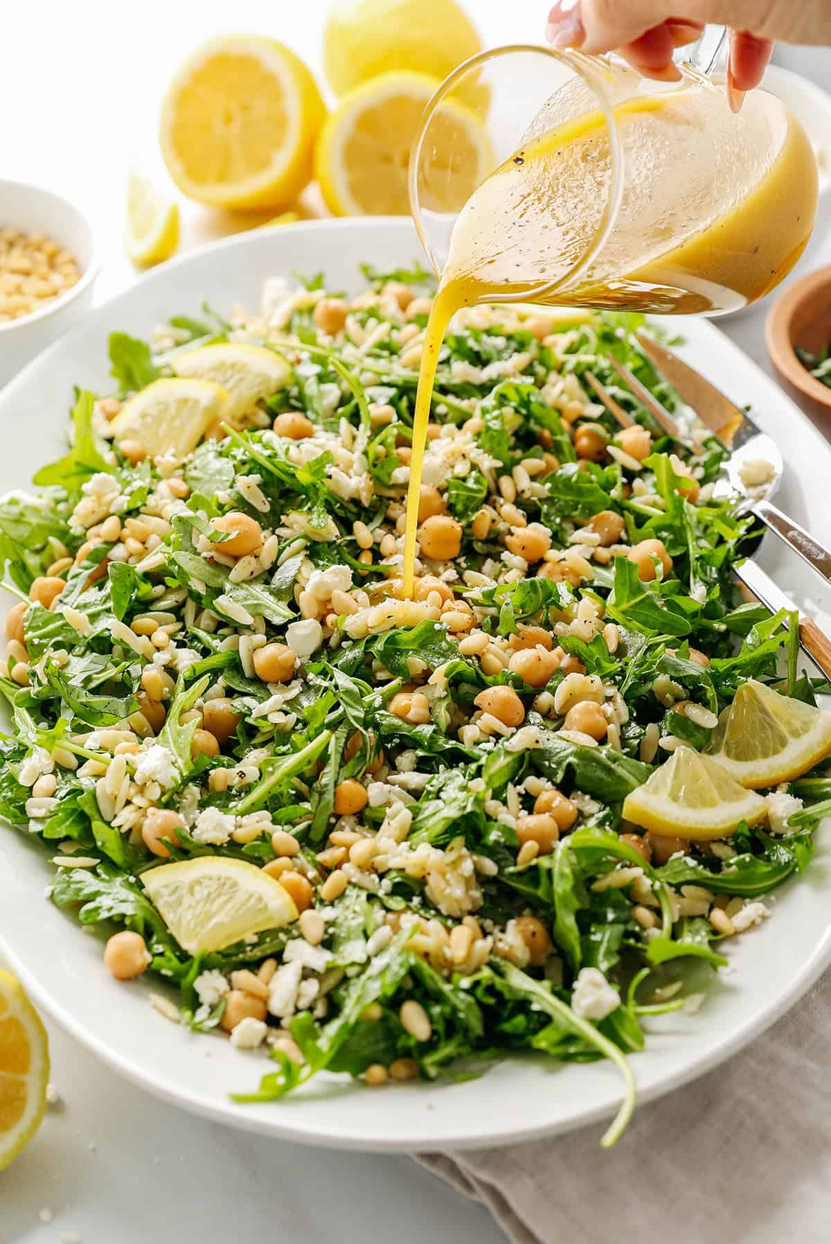 This Lemon Arugula Orzo Salad is a bright, zesty pasta salad packed with fresh greens, tender orzo, protein-packed chickpeas, crumbled feta cheese and a simple lemon dressing. Perfect for spring and summer meals!