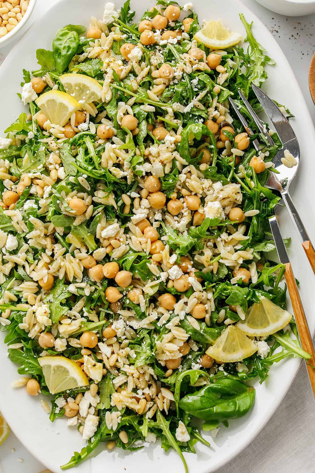 This Lemon Arugula Orzo Salad is a bright, zesty pasta salad packed with fresh greens, tender orzo, protein-packed chickpeas, crumbled feta cheese and a simple lemon dressing. Perfect for spring and summer meals!